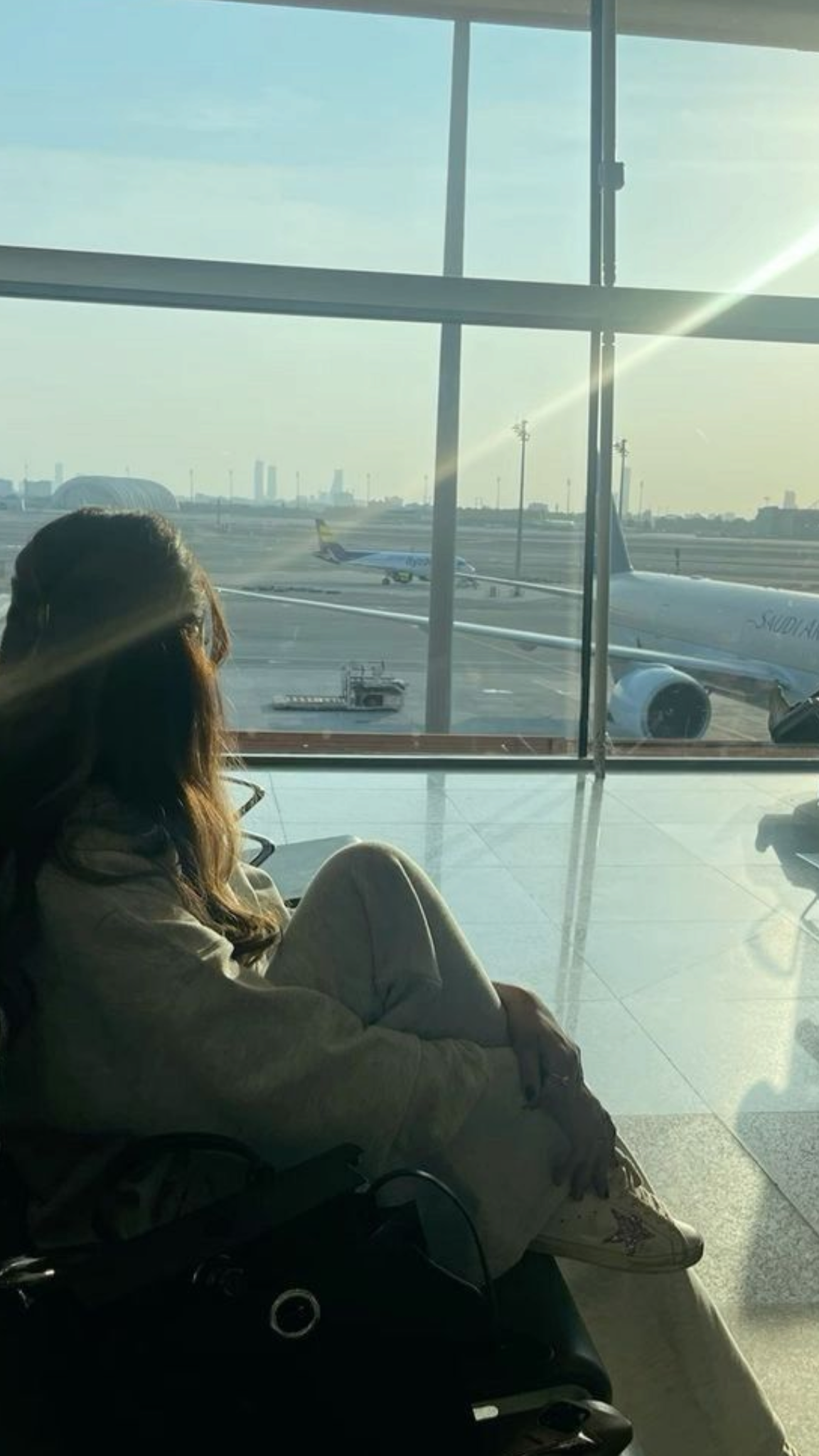 Quiet moment by a large airport window