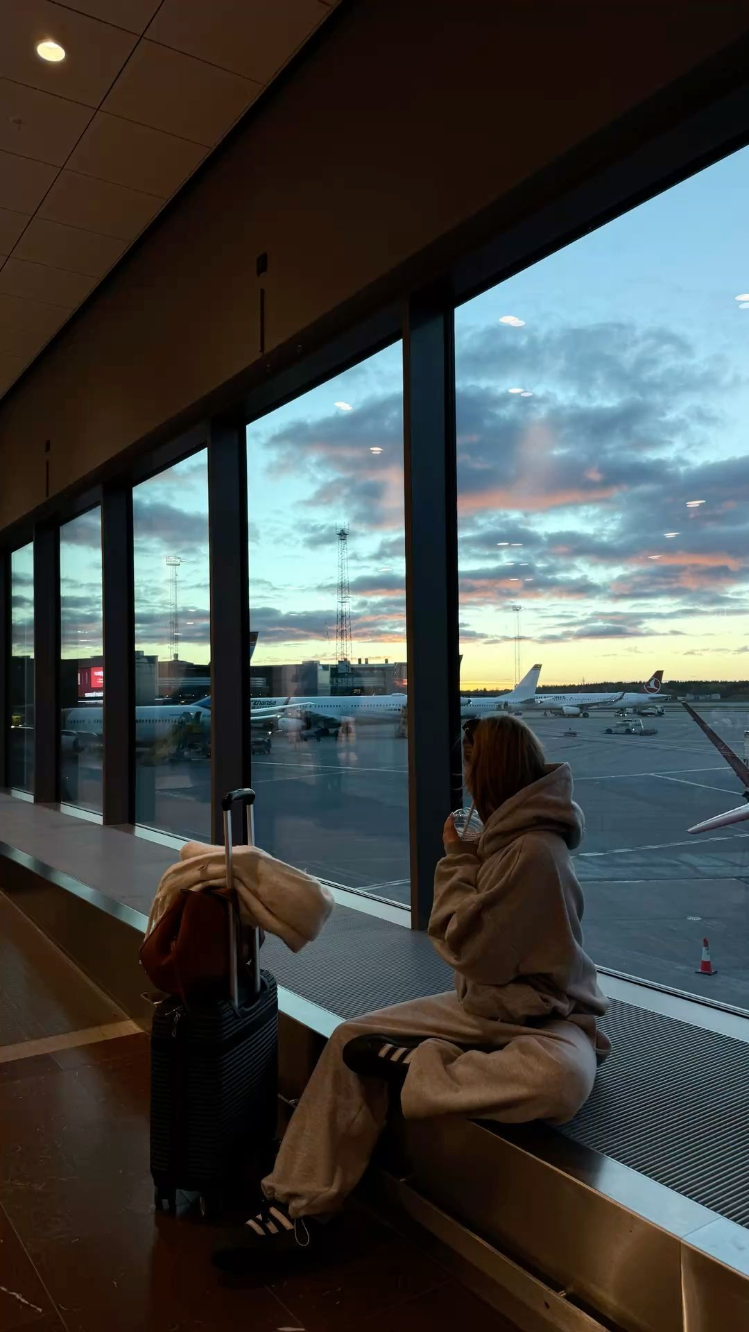 Airport window at sunset